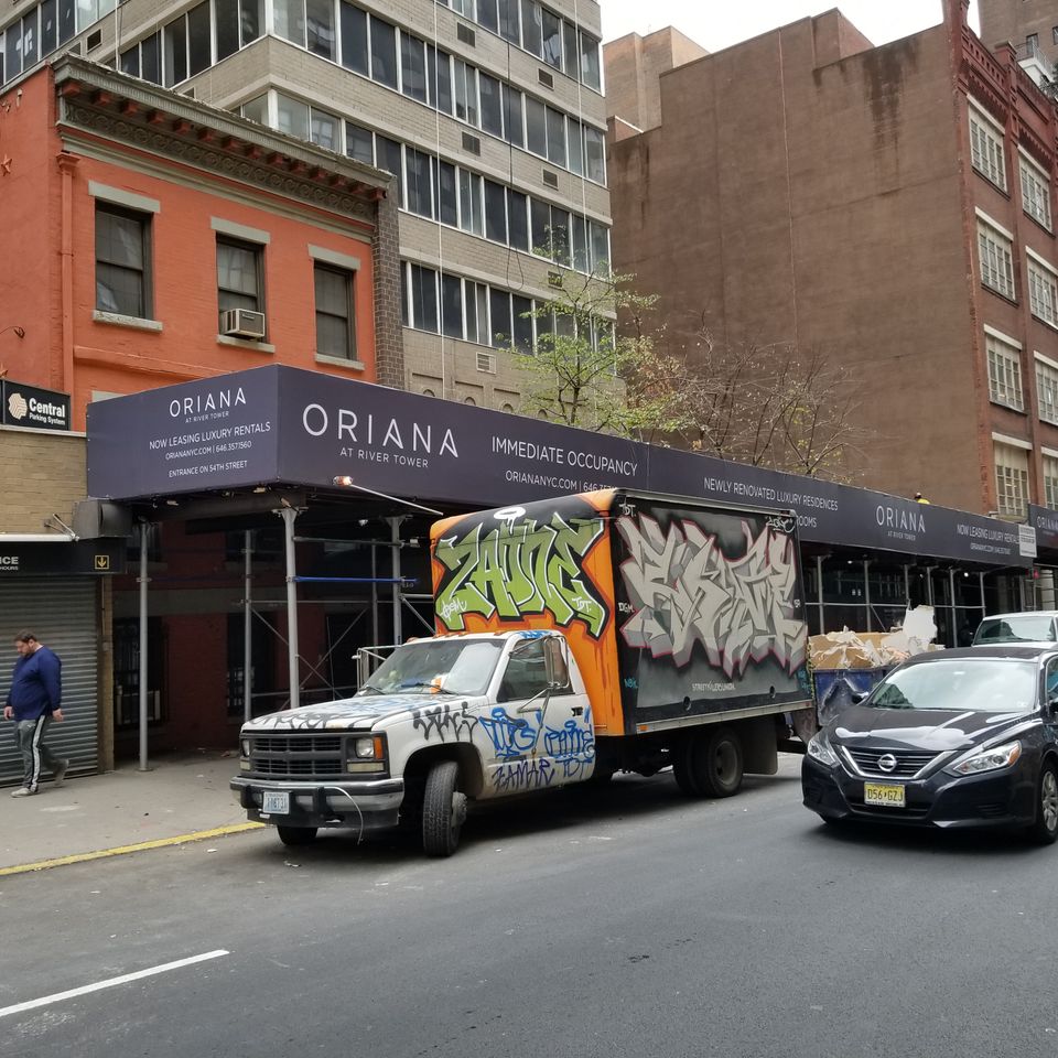 Printed banner running the full length of a sidewalk shed on a Manhattan block