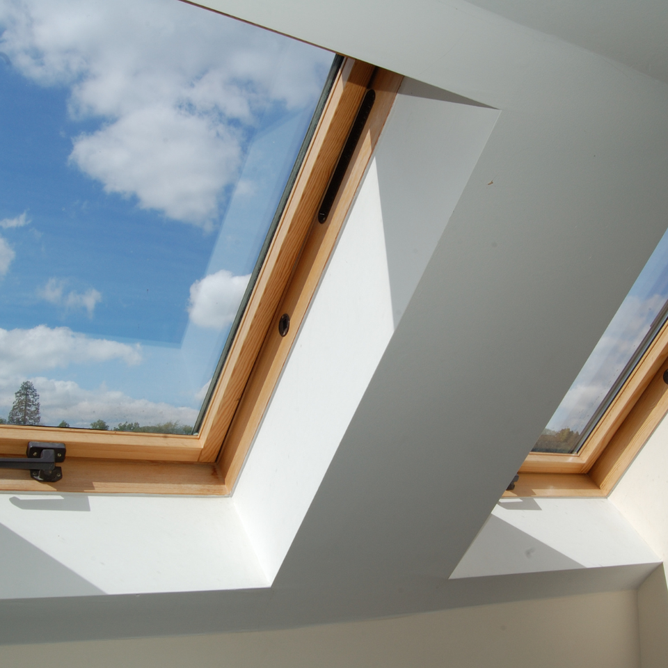 Two energy-efficient skylights installed on a residential roof, bringing natural light into the home by E & D Roofing, Inc.