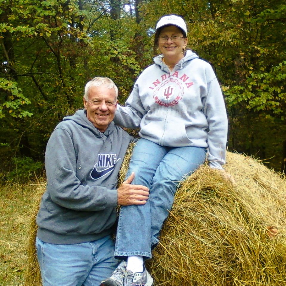 Pete and wife on bale of hay