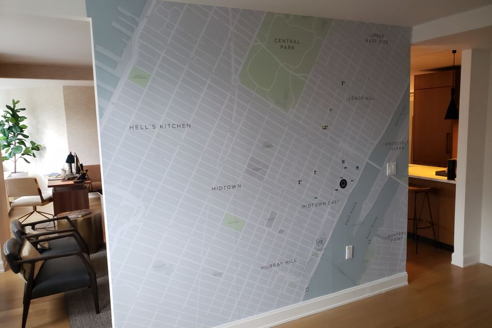 Printed vinyl wall graphic of a city street map covering an interior wall from floor to ceiling