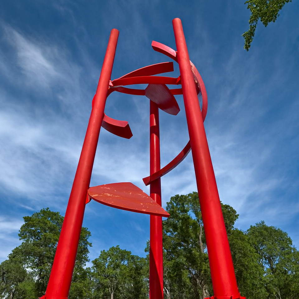 Roseville California public art landmark with red steel structure and lush park setting