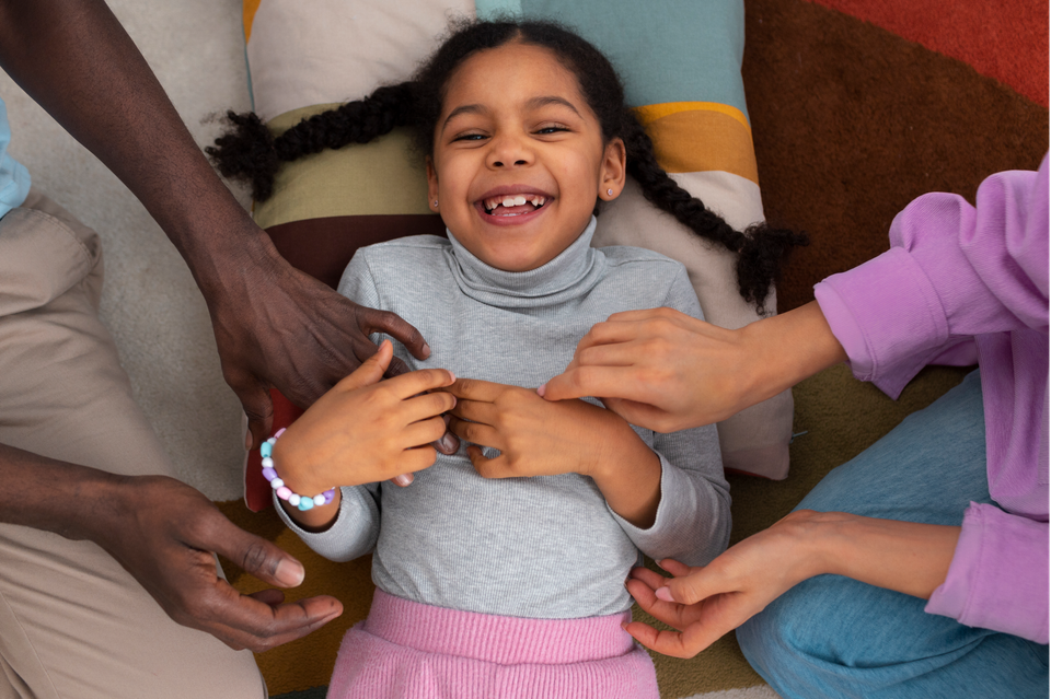 Top view girl being tickled by parents 1