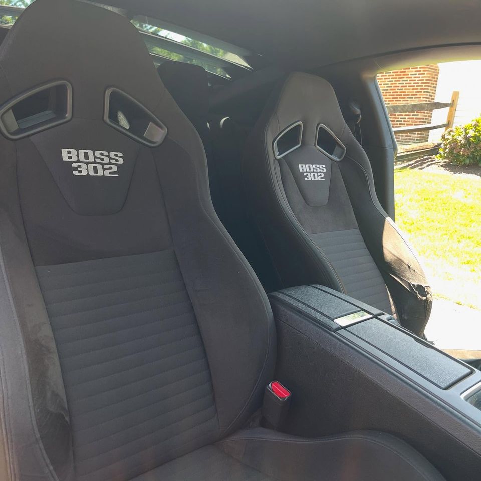 Black cloth Boss 302 sport seats cleaned and refreshed during an interior detail