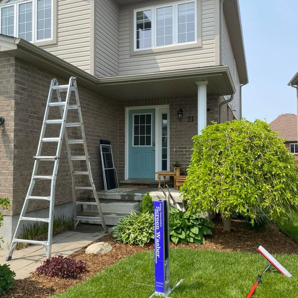 Ladders and screen washer set up for window cleaning at a two-story home in Tillsonburg Ontario