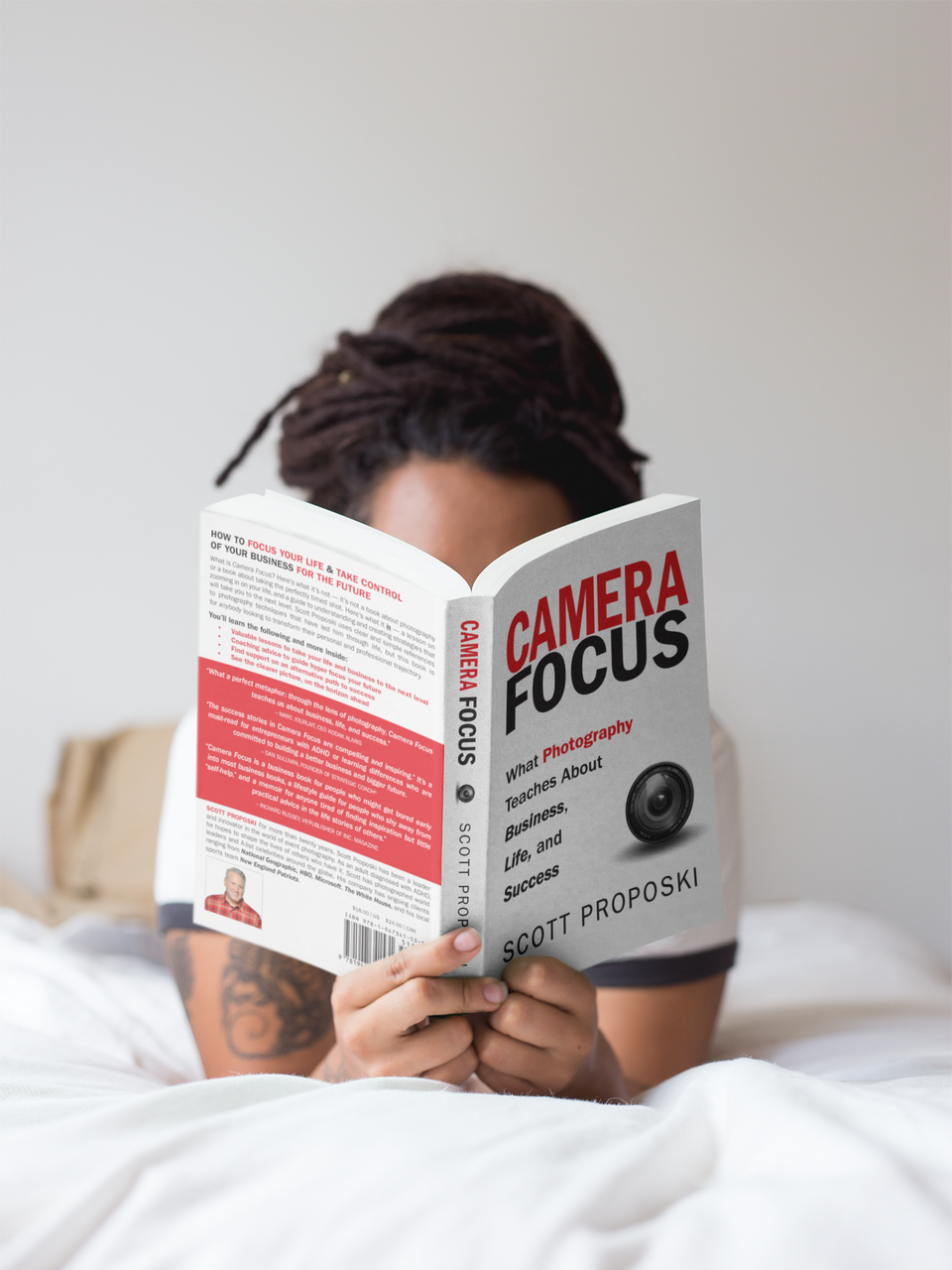 Girl with dreadlocks reading a book mockup while in bed a17301