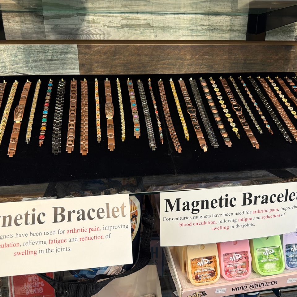 Sleek magnetic therapy bracelet displayed on a colorful counter at Yum Yum Vape Shop.