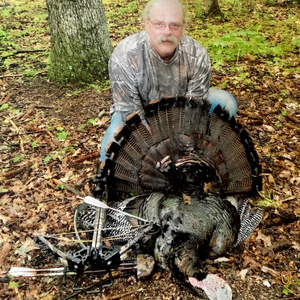  Tim Martin showing the turkey he shot with a crossbow.