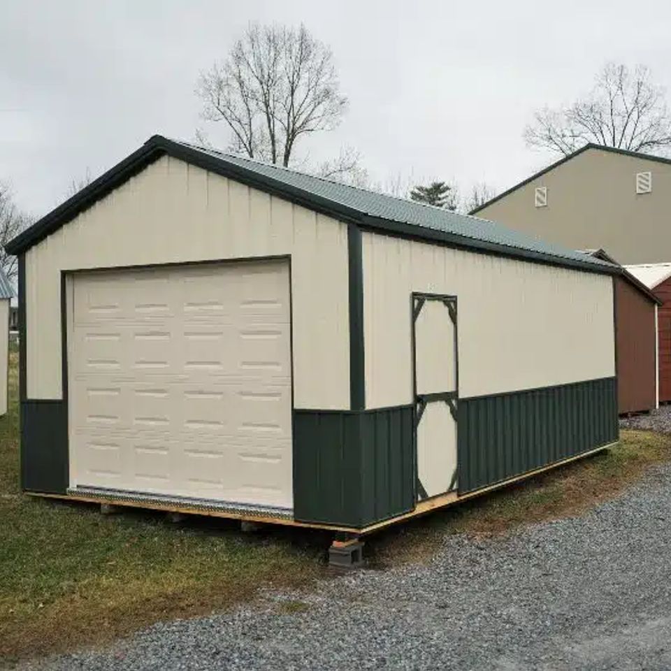 Cream and green cottage garage with white overhead door on a Elizabethton TN sales lot