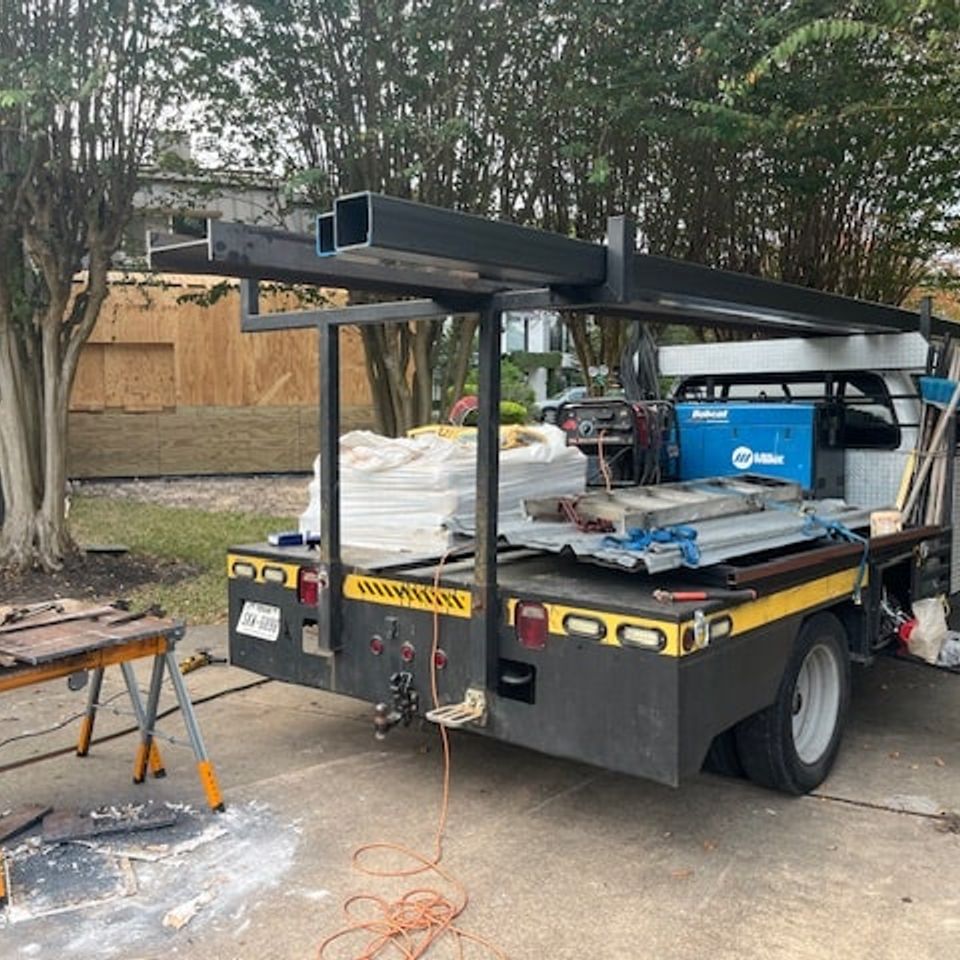 Custom steel beams loaded and prepped on the Marquez Welding service truck for an on-site fabrication projec