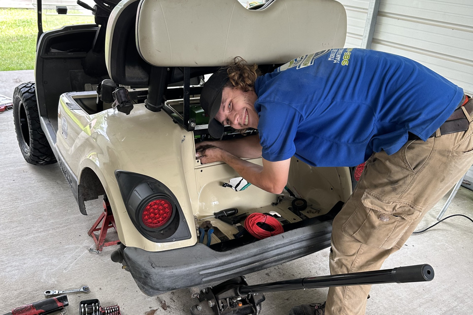 Technician Jake performing mobile golf cart repair service in Metairie, LA
