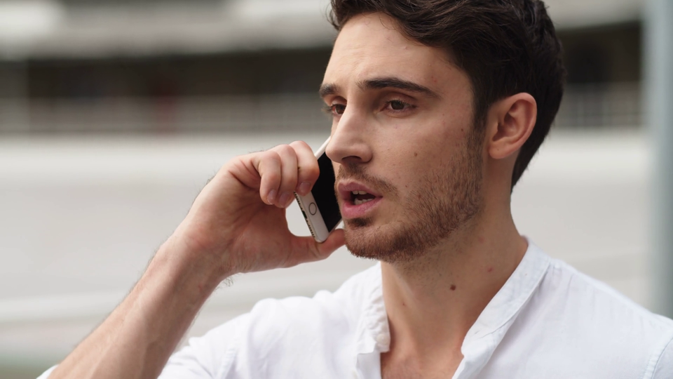 Videoblocks portrait of serious businessman having conversation on mobile phone outside close up of young man call phone outdoor smart guy having phone talk about work outside rwzdmnups thumbnail 1080 06