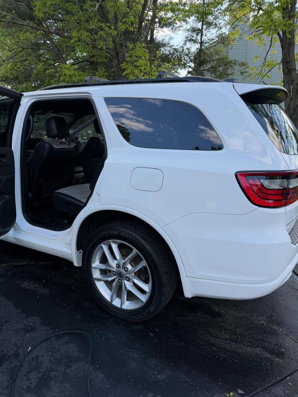 White Dodge Durango with dressed tires and spotless rear interior after a full detail