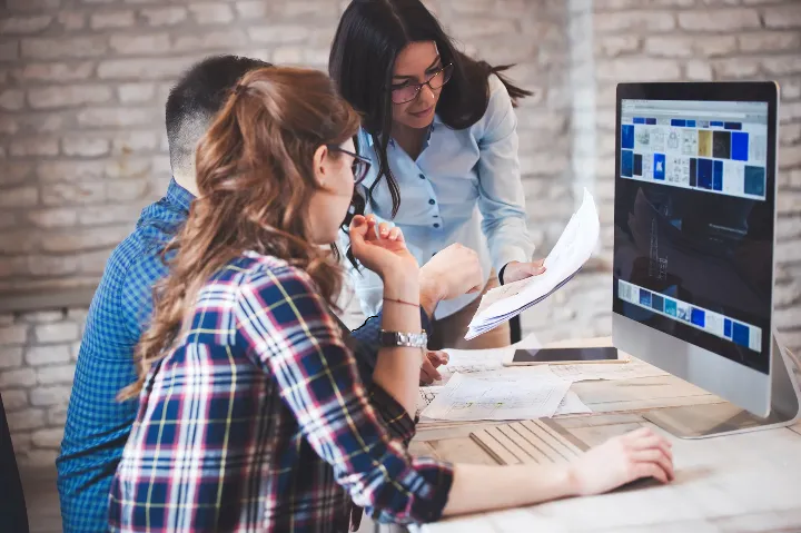 Web design team collaborating on custom website strategy for a client.