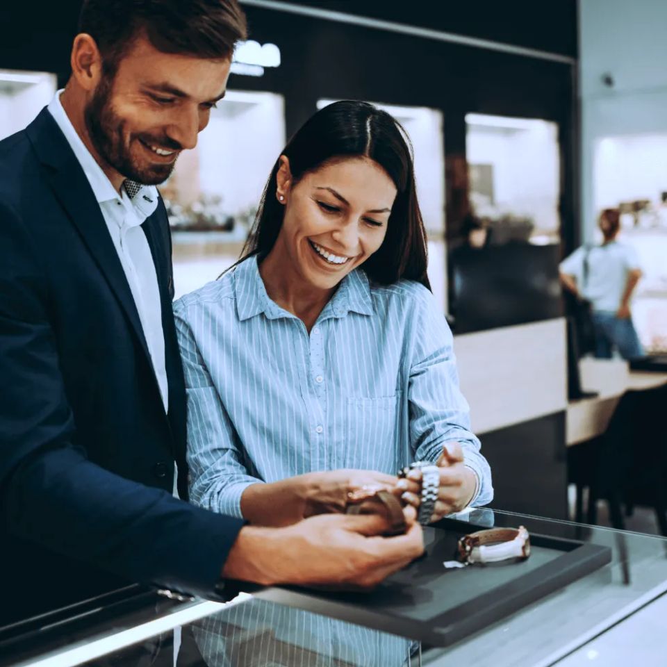 Couple looking at watches in jewelry store