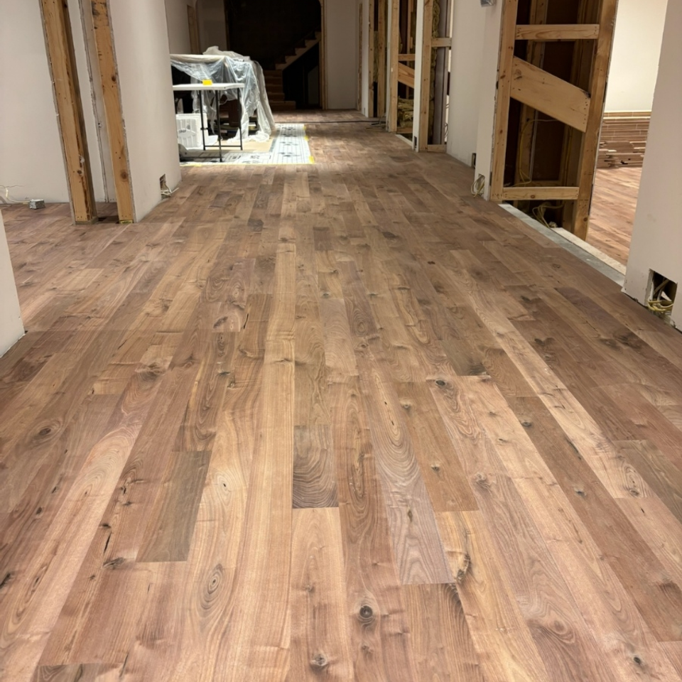 Wide plank wood flooring installed down a hallway during a home renovation in Chagrin Falls OH