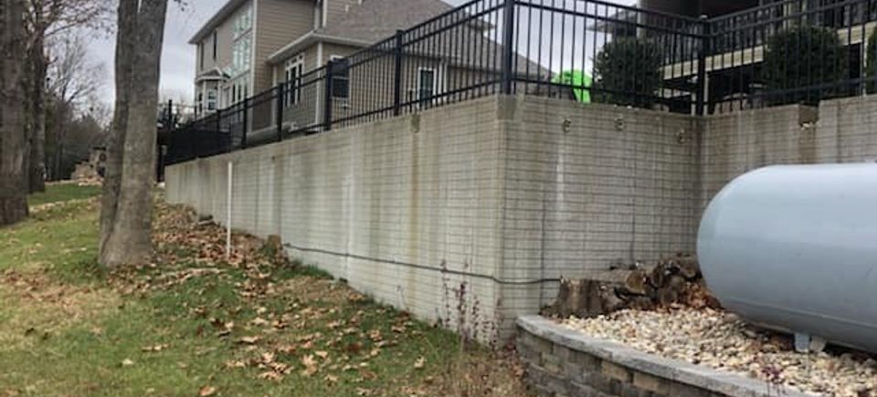 Residential iron fence on brick wall