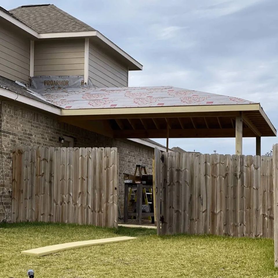 Covered patio roof installation in progress at a backyard home project in Spring Texas