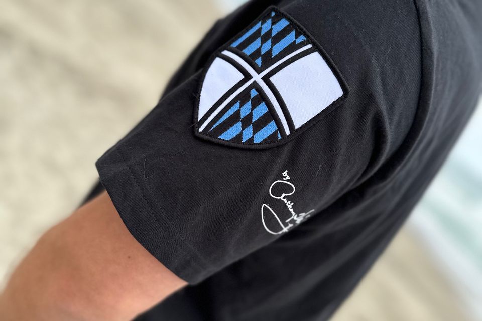 Black tee with blue black brick and white shield side view