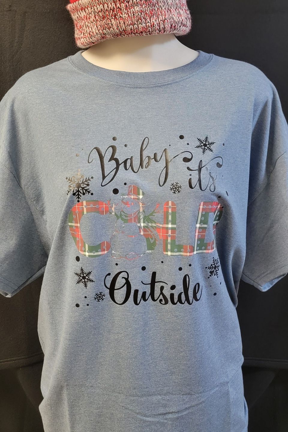 This t-shirt is an example of direct-to-film transfer (DTF) and has a design that says "Baby it's Cold Outside".
