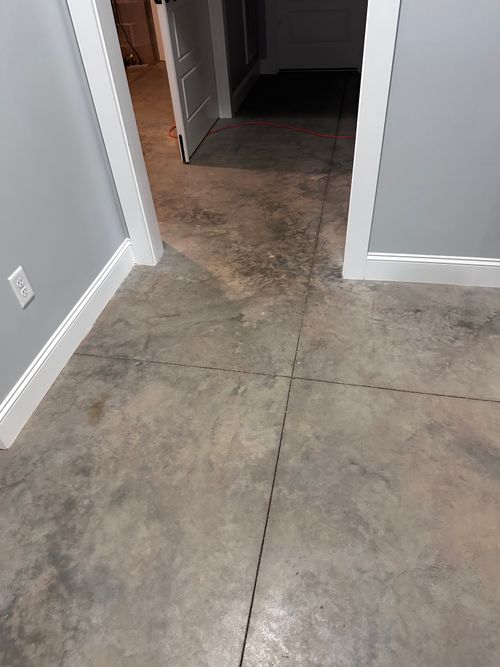 Decorative concrete basement flooring viewed through finished interior doorway