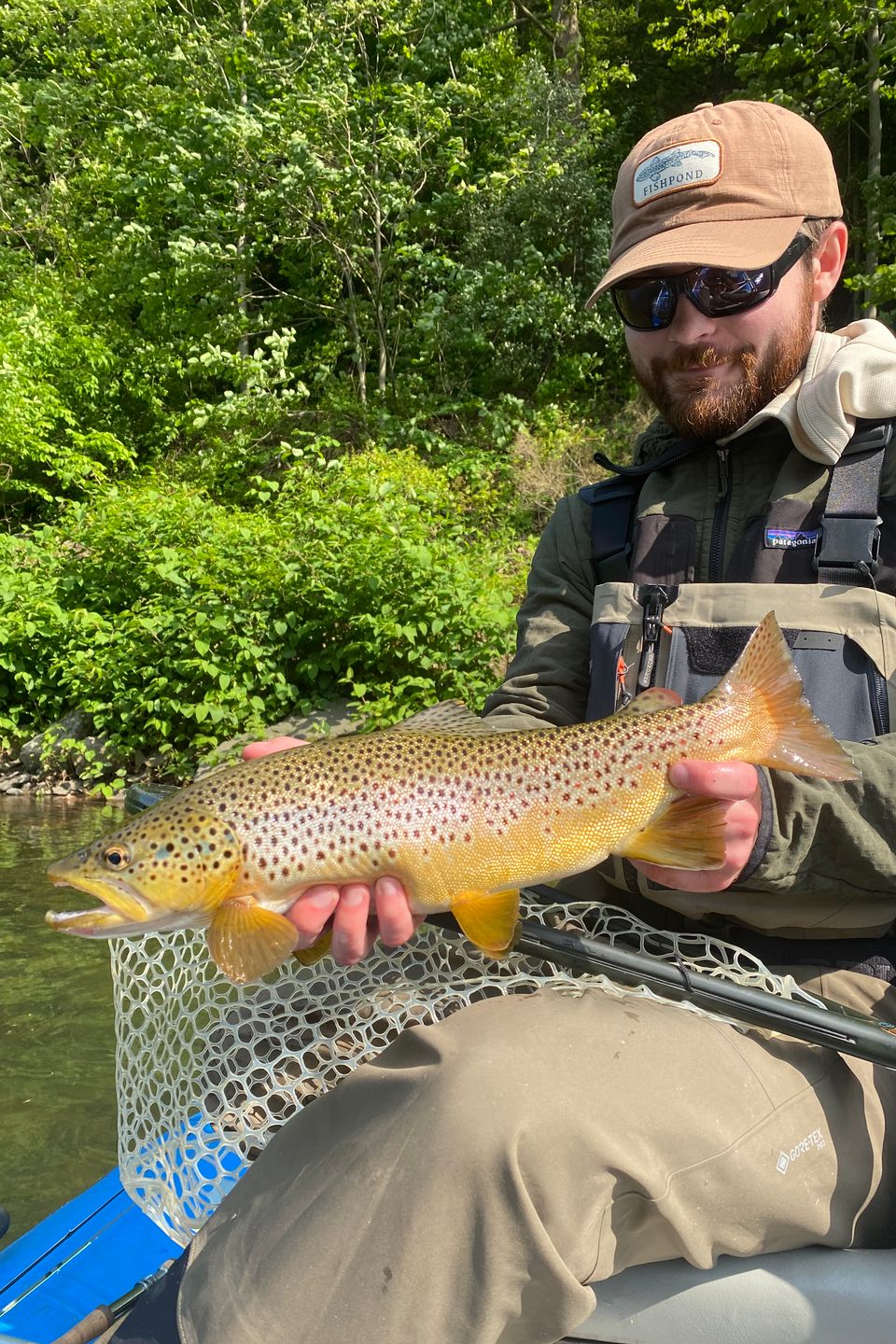 Avid outdoorsman, Evan Buck holding the trout he caught