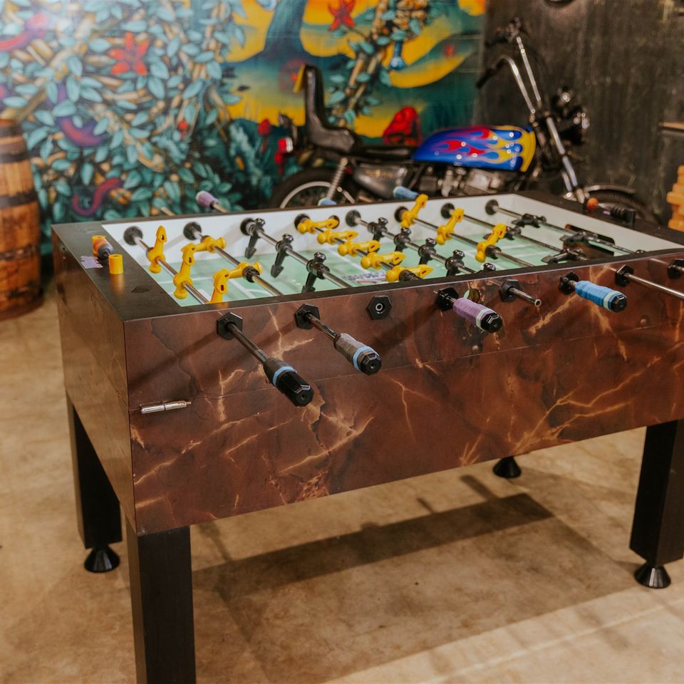 Foosball table with motorcycle in background