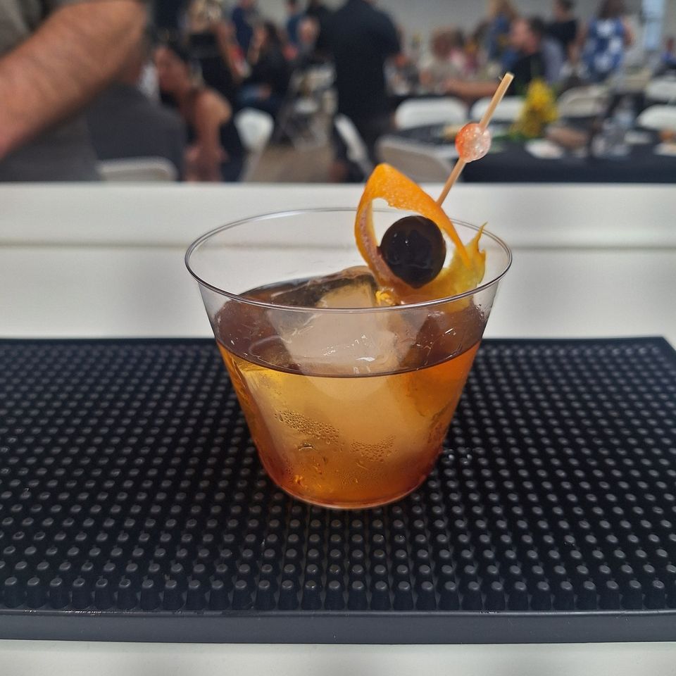 Old fashion cocktail with orange peel and cherry garnish ready to go