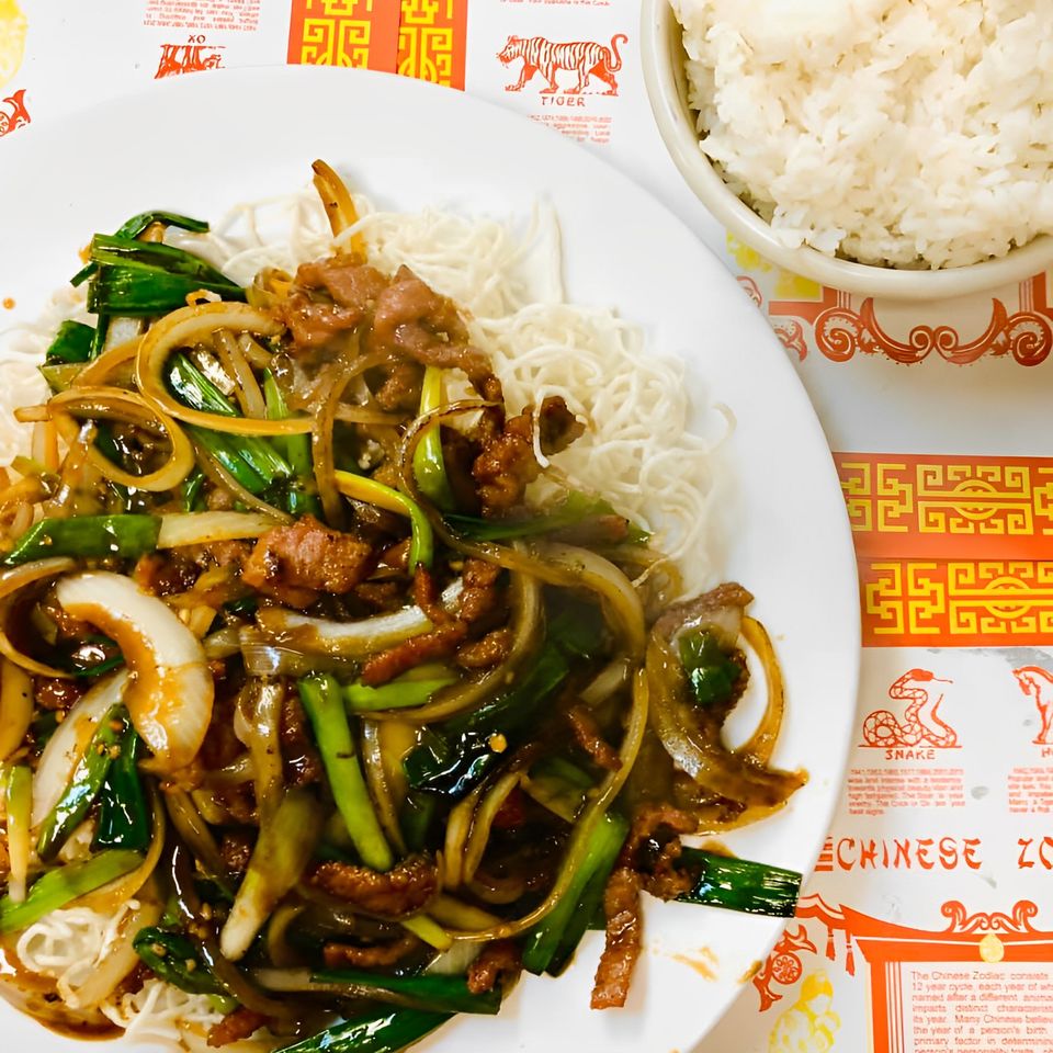 Freshly prepared entrée with vegetables, savory sauce, thin noodles, and a side of steamed white rice.