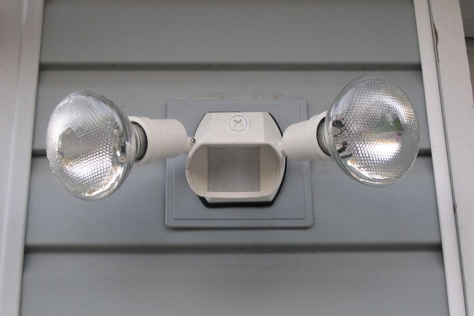 A set of security lights with motion detector installed outside house