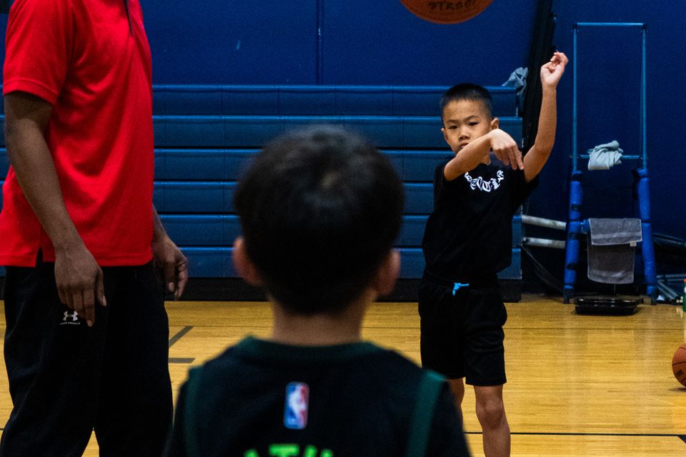 Youth athletes training and developing shooting skills in basketball