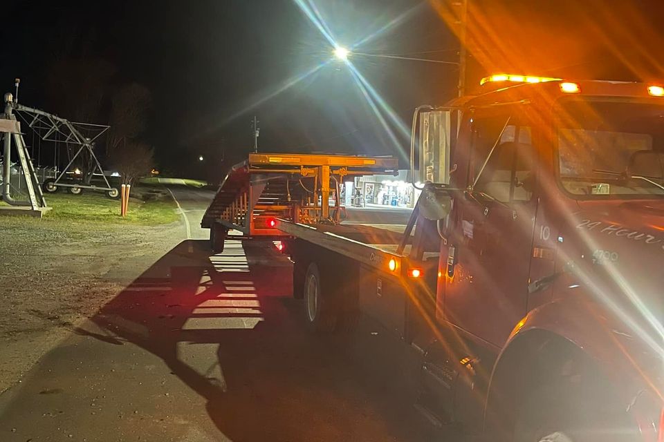 Figs towing red truck and car hauler
