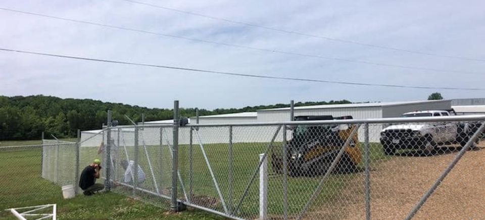 Dore family installing chain link automatic gate