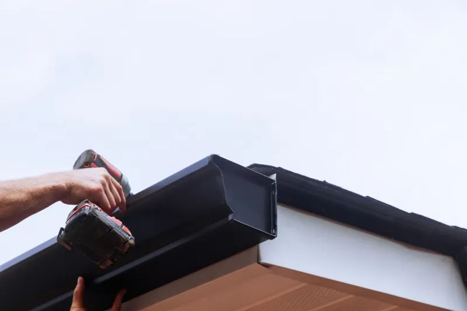 Worker installing rain gutter on roof is mounting 2025 03 27 06 01 04 utc scaled.jpg