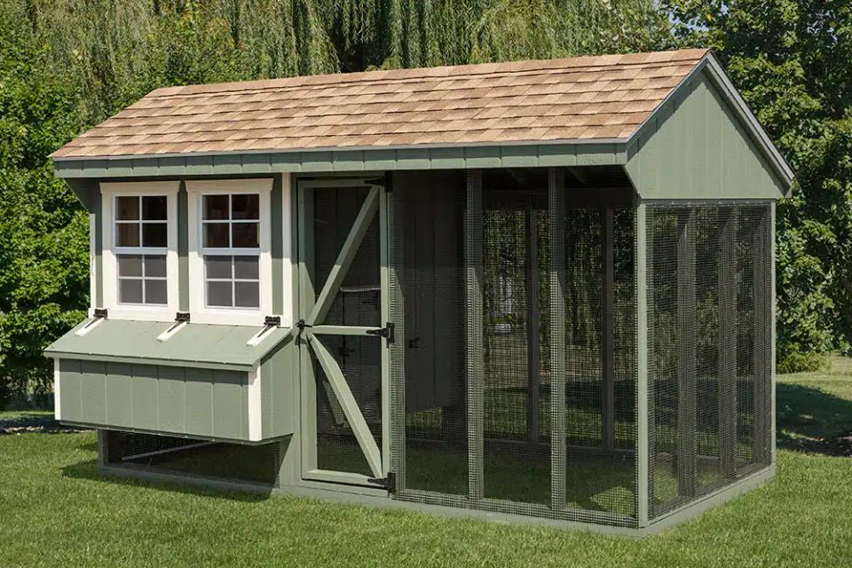Green Quaker chicken coop with nesting box and wire run installed on a Knoxville TN lawn