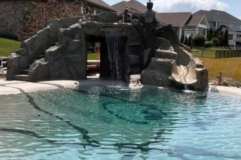 ClifRock stonework surrounding a swimming pool and waterfall feature.