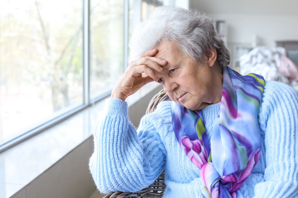 Portrait of sad senior woman in nursing home