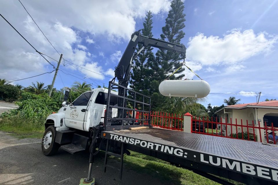 Crane truck lifting propane tank
