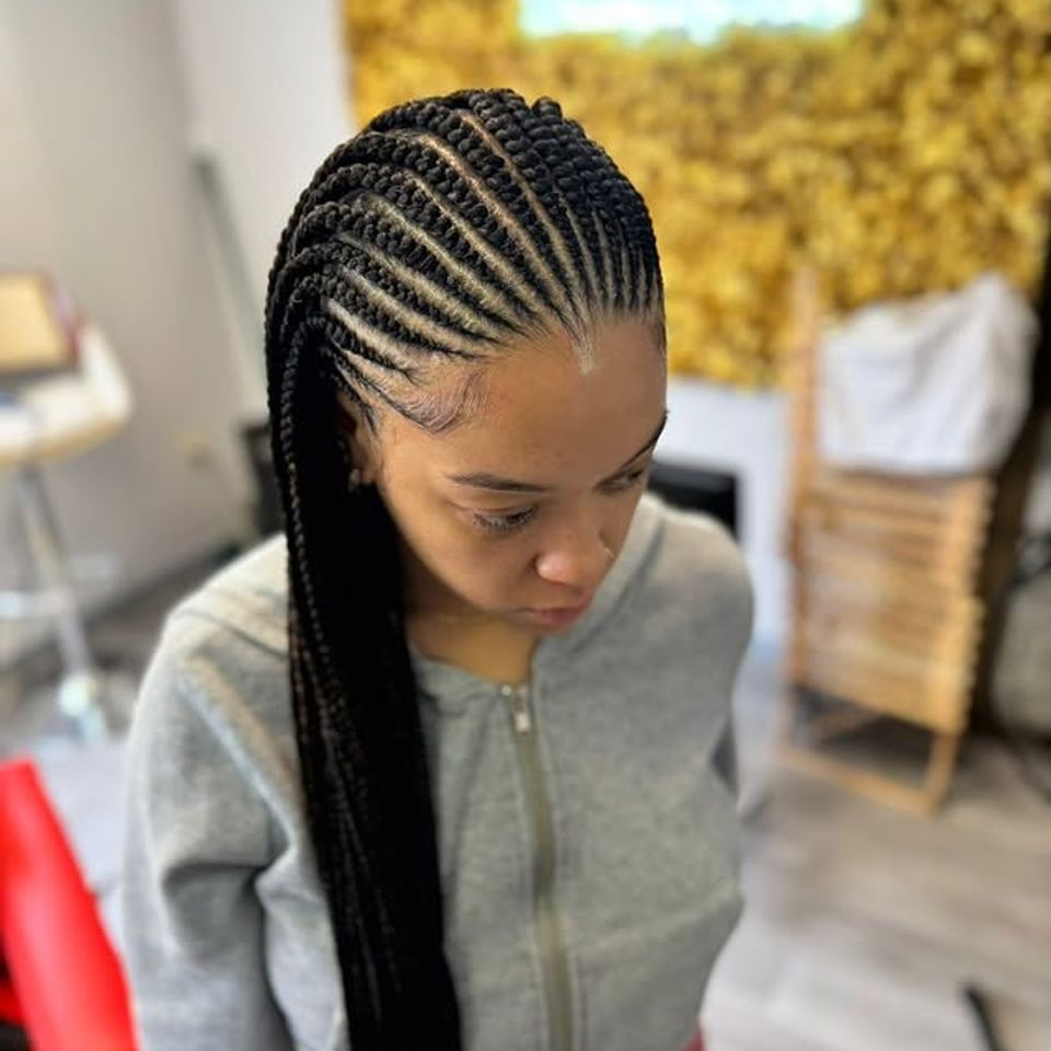 Sleek feed in cornrow braids styled into a long ponytail in Los Angeles CA