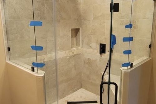 Frameless glass enclosure taped for curing on new tile shower in Montgomery, TX