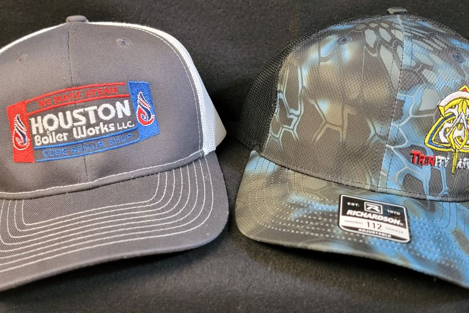 Embroidered logos on gray baseball caps