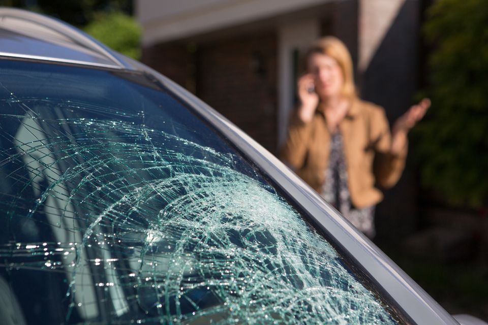 Cracked vehicle windshield after impact, highlighting the need for professional windshield replacement.
