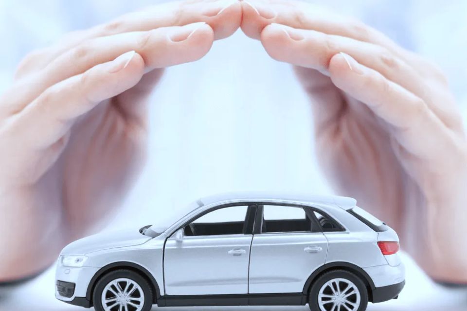 Person placing hands protectively over small model car