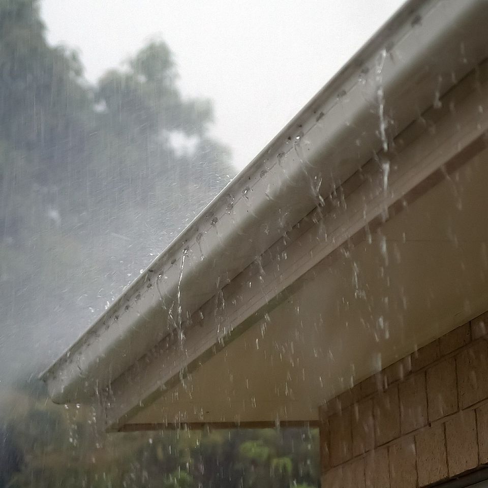 Rain flowing through clean gutters.