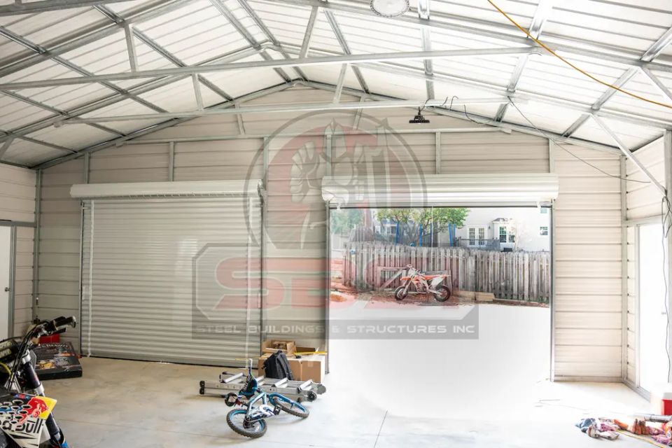 Garage door open of steel building structure, with SBSI watermark representing steel building interiors in Alabama