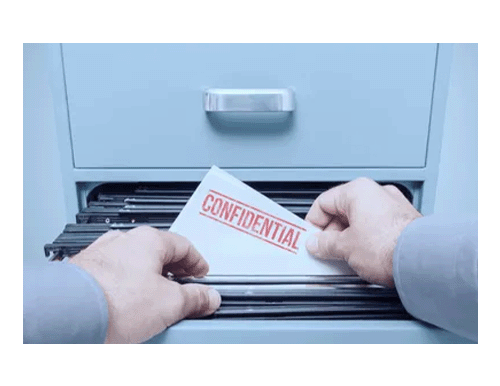 Employee taking confidential documentation out of filing cabinet