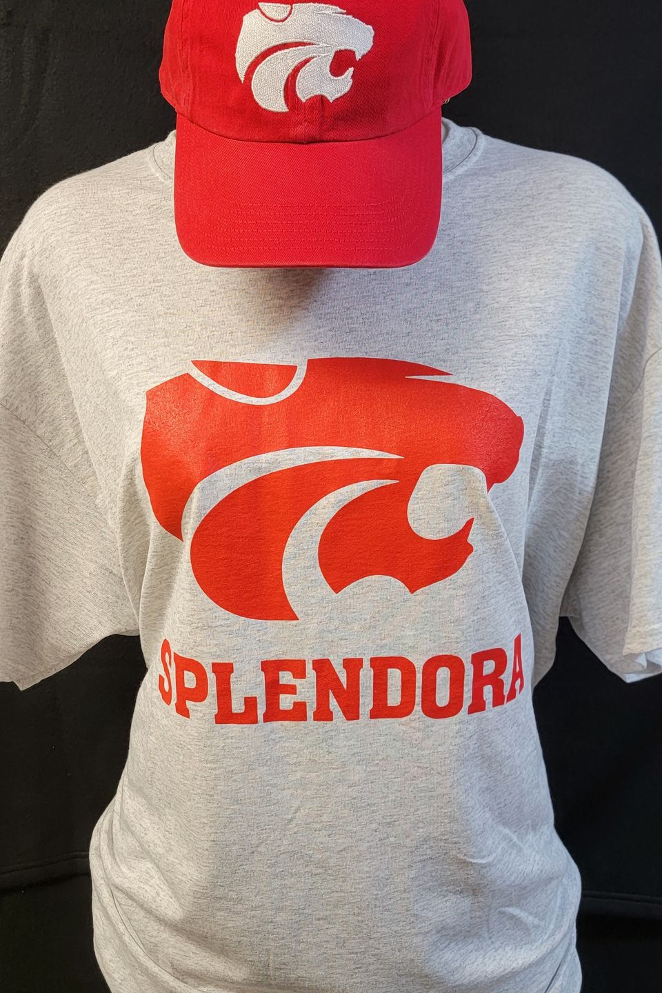 Example of Direct to Film (DTF) transfer - Splendora ISD HS logo on a gray t-shirt, & embroidered logo on a red cap 