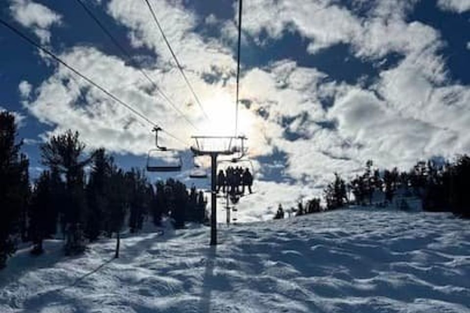Photo of chairlift from the perspective of someone on the chairlift