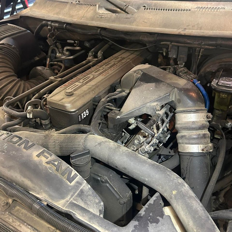 Dodge Cummins turbo diesel engine bay during truck repair service in Arab Alabama