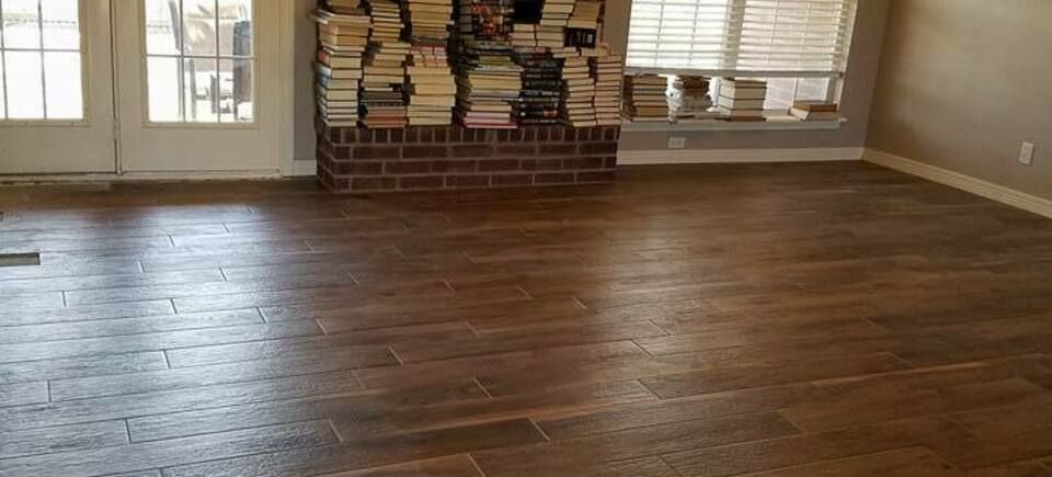 Weathered wood restoration  tulsa oklahoma  wood look tile floor in a remodeled living room