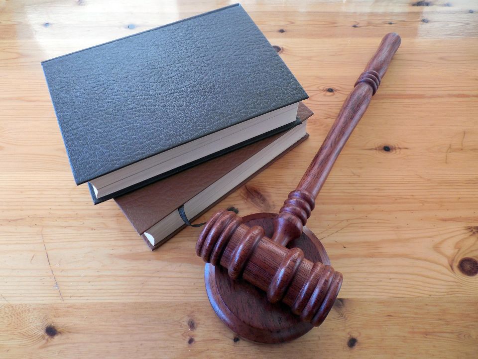 stack of books with legal hammer